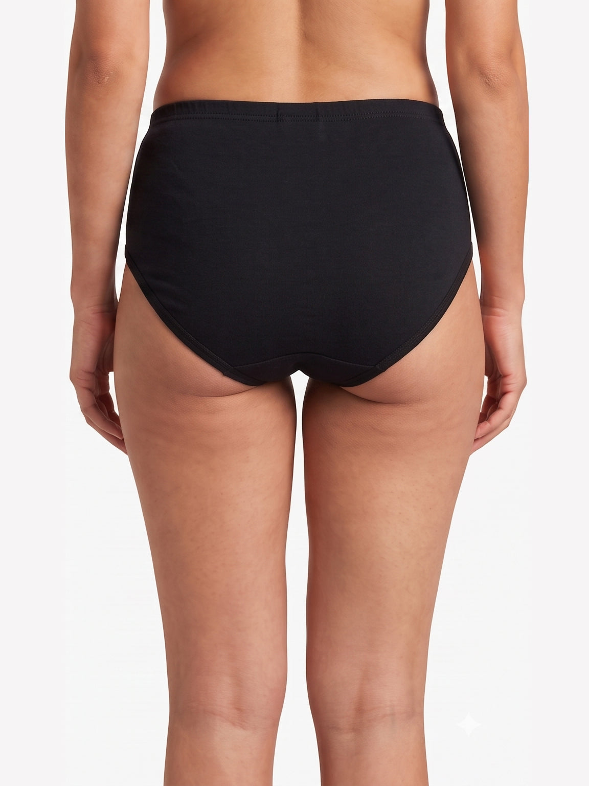 Rear view of a model wearing black high-waisted briefs against a plain white studio background.