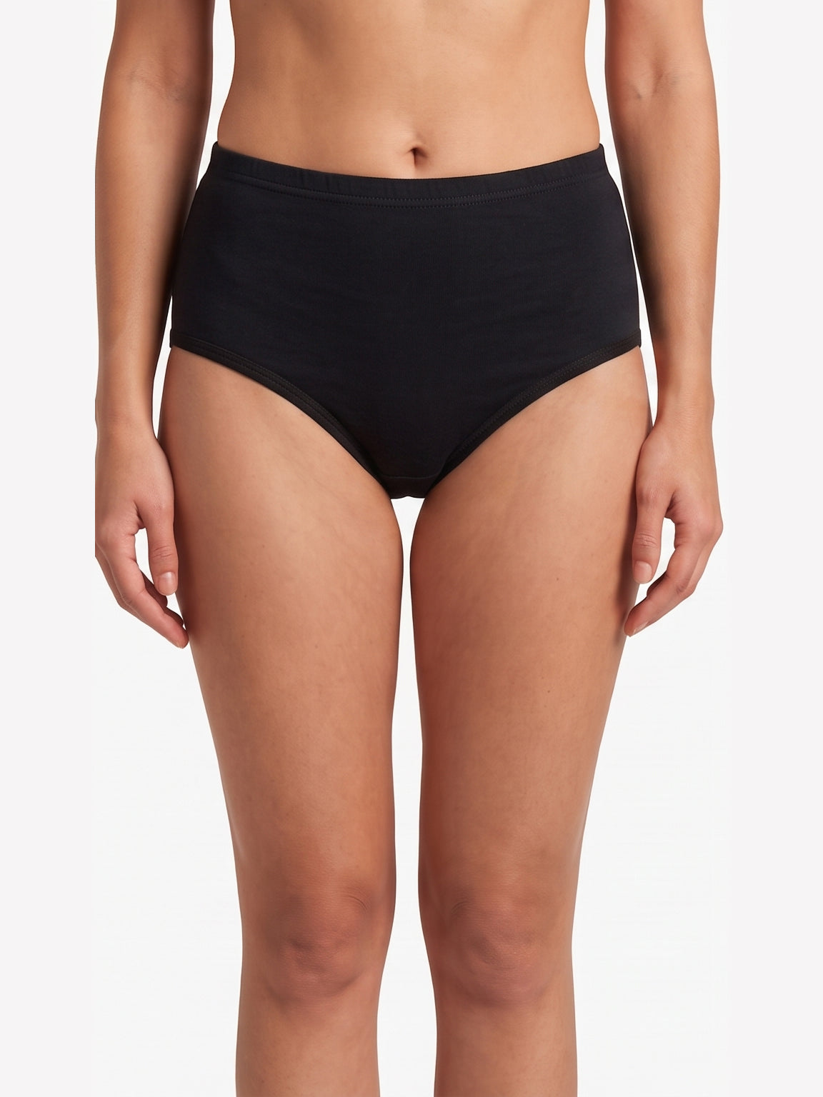 A model wearing a pair of black high-waisted briefs against a plain white studio background.