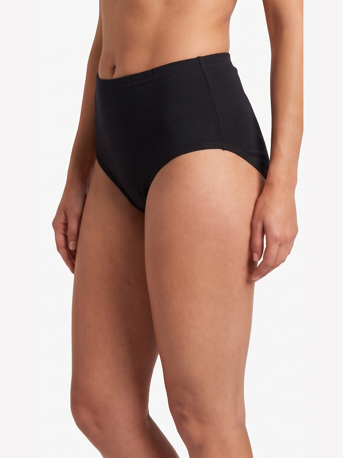 A model wearing black high-waisted briefs against a clean white studio background.